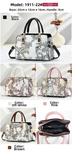 Macro detail of paisley embossed tote bag with gold hardware and shoulder strap