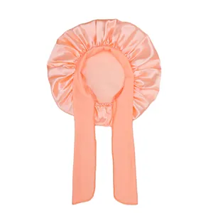 Detailed view of pink satin hair sleep bonnet with long adjustable ribbons and ruffle edge