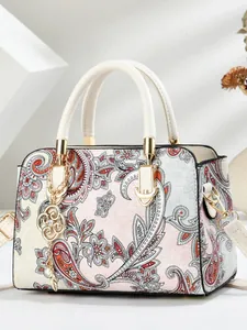 Elegant floral paisley tote bag with white handles and golden flower pendant charm