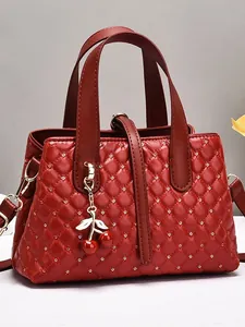Elegant deep red quilted handbag with diamond studs and cherry pendant for wedding