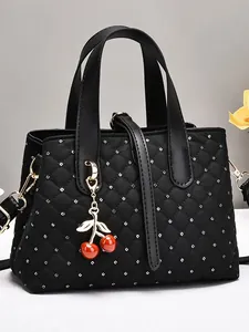 Quilted black bridal handbag with silver polka dots, cherry charm and shoulder strap