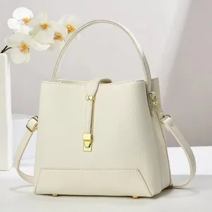 Large off-white pebble leather bucket bag with gold hardware and top handle