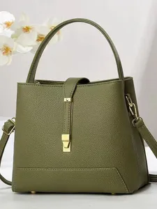 Dark green lychee pattern leather bucket bag with top handle and adjustable strap