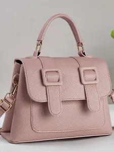 Minimalist square crossbody bag in textured pink leather with golden metal hardware details