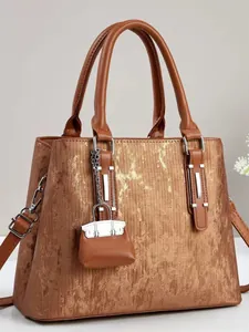 Brown textured tote bag for women with gold foil accents and a matching mini pouch charm