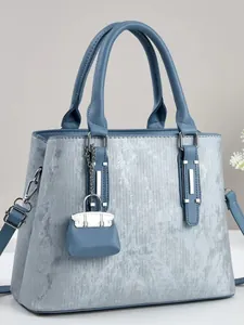 Elegant light blue textured handbag with matching micro bag charm and dual handles