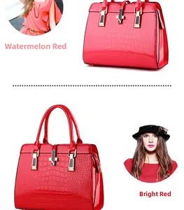 Close-up of crocodile pattern glossy patent leather handbags with gold hardware detail