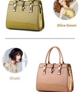 Detail view of glossy croc-embossed patent leather tote bags in green and khaki