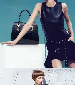 Close-up of black crocodile pattern handbag with elegant gold metal lock and texture
