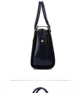 Side view detail of a navy blue faux crocodile leather handbag with glossy finish