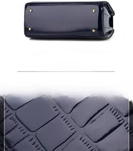 Detail of dark blue crocodile embossed patent leather bottom with gold protective studs
