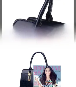 Detailed view of crocodile pattern patent leather handbag with sturdy gold metal hardware