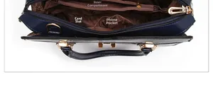 Interior view of crocodile pattern handbag showing zip pocket and card slots