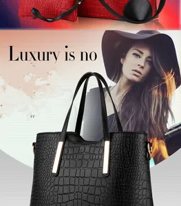 Detail of black crocodile texture tote bag with gold metal bars and large capacity