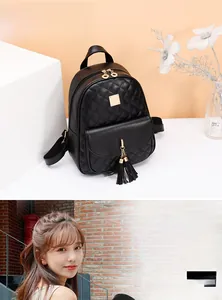 Detail of black quilted PU leather mini backpack with metal tassel and adjustable straps