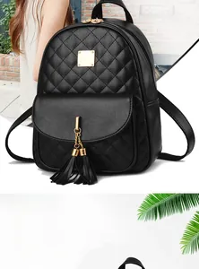Close-up of black quilted leather backpack featuring gold hardware and fringe detail