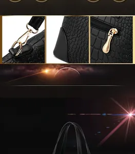 Detailed macro view of black crocodile pattern embossing with gold-tone metal hardware