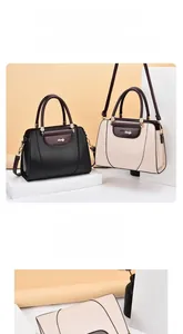 Detail showing litchi textured tote bags in black and wine red with dual handles