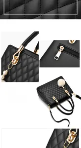 Detail of black quilted handbag featuring gold hardware and pearl fur pom pom charm