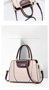 Macro detail of elegant cream tote bag with brown handles and gold logo accents