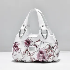 Elegant white tote bag with purple floral print and metallic triangle buckles