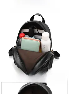 Interior view of black quilted mini backpack showing large capacity and practical layout