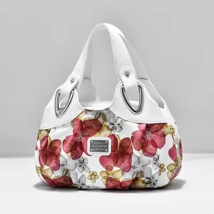 Women's white floral print handbag with leather top handles and silver metal hardware