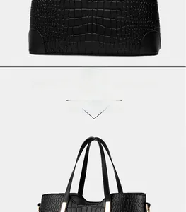 Macro shot of black crocodile embossed leather texture with gold metal hardware on tote bag