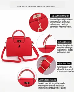 Detail view of red handbag featuring gold deer charm and adjustable shoulder strap