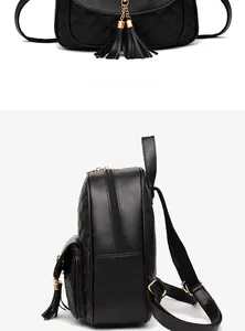 Detail view of black quilted backpack featuring golden tassel charms and luxury texture