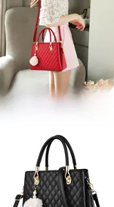 Close-up of quilted leather handbag with plush fur ball charm and golden hardware