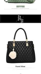 Close-up of quilted handbag with elegant gold metal rings and a soft white faux fur pompom