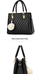 Side view of black quilted handbag with classic diamond pattern and white faux fur pompom