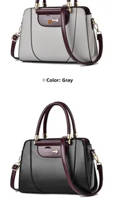 Detail view of stylish grey and charcoal handbags with contrasting burgundy handles and gold trim