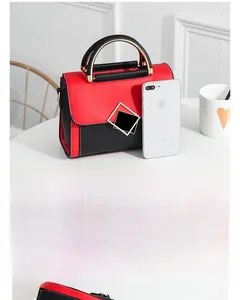 Detailed view of color-block PU square handbag with metal handle and phone size comparison