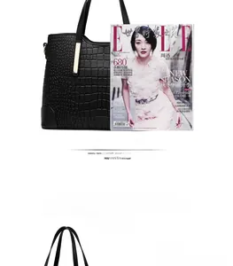 Macro detail of spacious black crocodile pattern tote bag compared to A4 magazine size