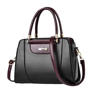 Fashionable black and burgundy leather tote bag with gold metal logo and shoulder strap