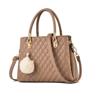 Brown quilted handbag for women with dual top handles and decorative white pompom charm
