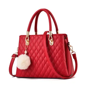 Red quilted leather handbag with chic diamond embroidery and white fur pom-pom charm