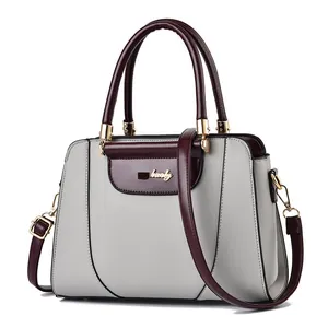Chic light gray leather crossbody handbag with burgundy handles and gold hardware