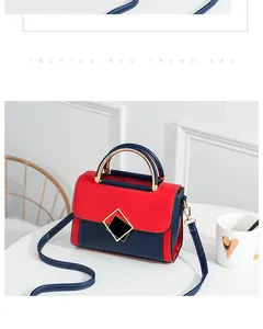 Detail of red and navy color-block PU crossbody bag with gold hardware buckle