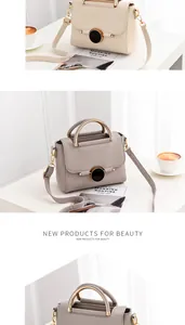 Detail of lychee pattern leather bags with round metal handles and disc lock closure