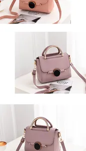 Detail of small rose pink leather handbag with black circular metal clasp and handle