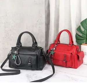 Detailed view of high-quality Boston bags in black and red with chic tassel charms