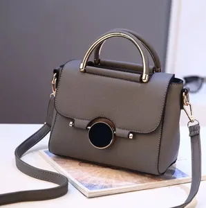 Elegant grey structured handbag with round metal handle and shoulder strap for women