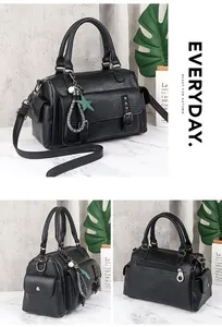 Detailed close-up of a black Boston bag featuring litchi texture and star charms