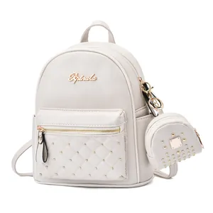 Detail view of white quilted leather backpack with gold studs and mini coin purse