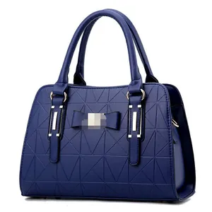 Navy blue handbag with geometric triangle embossing and a stylish bow decoration