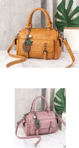 Detail of Boston bag showing lychee grain leather, star pendant and rivet pocket