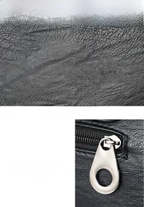 Close-up of black lychee leather texture and silver metal zipper on a Boston bag